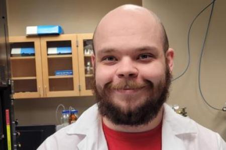 Johnathan Mayfield in a lab coat